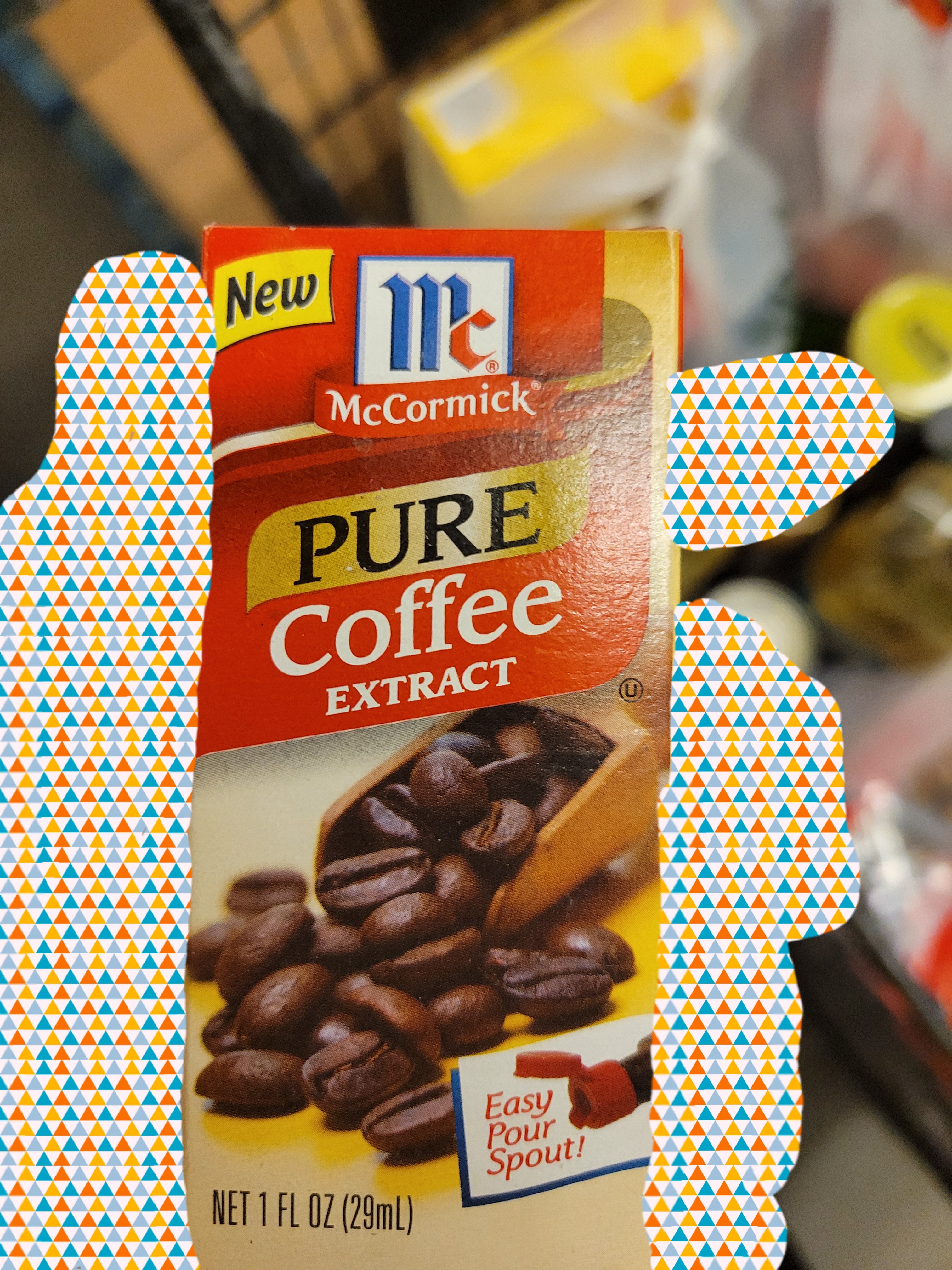 Hand holds box of coffee extract.